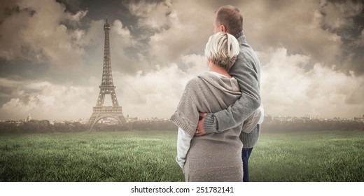 Happy Mature Couple In Winter Clothes Against Paris Under Cloudy Sky