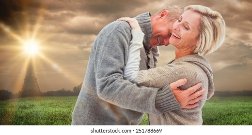 Happy Mature Couple In Winter Clothes Against Paris Under Cloudy Sky