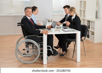 Happy Mature Disabled Businessman Having Meeting With Colleagues In Office - Powered by Shutterstock