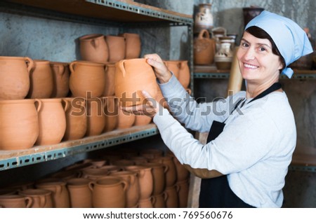 Similar – Beautiful ceramist owner looking to the camera while smiling