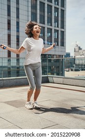 Happy Mature Female With Skipping Rope Outdoors