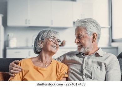 Happy mature husband and wife sit rest on couch at home hugging and cuddling, show care affection, smiling senior loving couple relax on sofa have fun, enjoy tender romantic family weekend together - Powered by Shutterstock