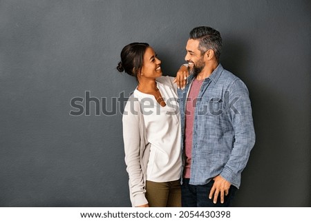 Similar – Image, Stock Photo A couple of adult lovers, sitting on a couch covered with a leopard pattern blanket, watch a romantic movie on television