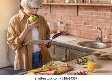 Happy Mature Lady Cooking At Home