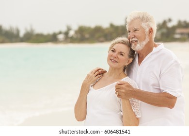 Happy mature male female Caucasian couple living a healthy outdoor leisure lifestyle on a Caribbean beach - Shutterstock ID 606481541