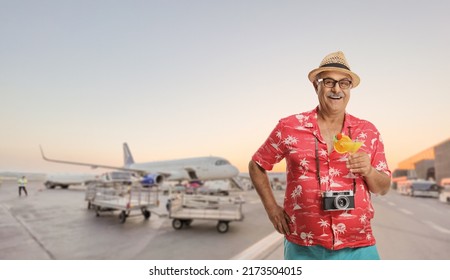 Happy Mature Male Tourist Posing On An Airport Apron