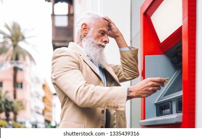 Happy Mature Man Withdraw Money From Bank Cash Machine With Debit Card - Senior Male Doing Payment With Credit Card In ATM - Concept Of Business, Banking Account And Lifestyle People