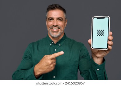 Happy mature middle aged business man holding smartphone in hand showing big mockup mobile screen pointing at mobile cell phone advertising new banking phone app isolated on grey background. - Powered by Shutterstock