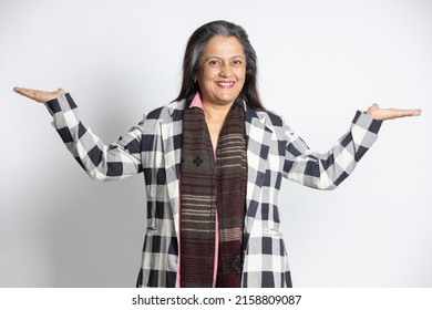 Happy Mature Middle Aged Indian Businesswoman Or Corporate Senior Lady Standing With Arms And Hands Raised Gesture Isolated On White Background, Smiling Asian Female 60s Gray-haired. Portrait