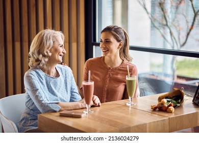 Happy mature mother and her adult daughter enjoying in conversation while spending Mother's day together in a cafe,. - Powered by Shutterstock