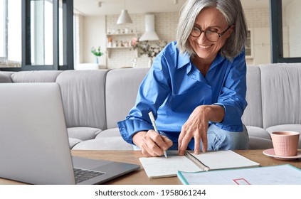 Happy Mature Senior Professional Business Woman Working On Laptop From Home Office, Having Virtual Video Call Meeting, Watching Online Training Webinar E Learning Class Using Computer.