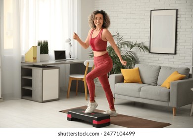 Happy mature sporty woman training with stepper at home - Powered by Shutterstock