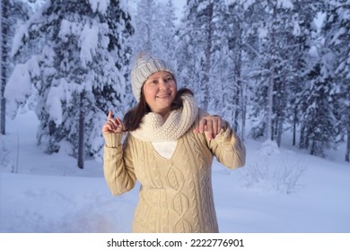 Happy Mature Woman 50 Years Old In Winter Forest, Early Evening In Park Among Snow-covered Trees, Beautiful Landscape, Smiling Happily, Concept Active Lifestyle, Good Mood, Enjoying Winter Nature