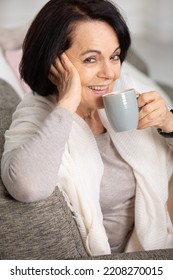 Happy Mature Woman Drinking Tea At Home