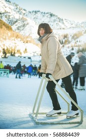 Happy Mature Woman Ice Skating At Medeo Skate Rink.