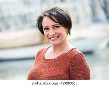 Happy Mature Woman Outdoors At Sunny Spring Day
