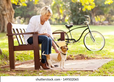 Happy Mature Woman With Pet Dog Outdoors