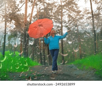 Happy mature woman with red umbrella enjoy in a forest under the rain - Powered by Shutterstock