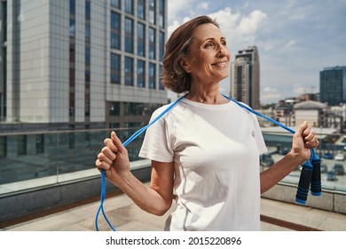 Happy Mature Woman Relaxing After Jumping Training