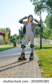 Happy Mature Woman Rollerblading In The Park Wearing Helmet, Protective Helmet, Knee Pads, Elbow Pads