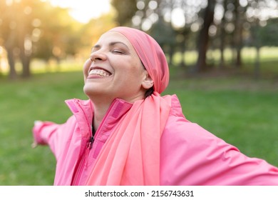 happy mature woman smiling with a pink scarf, symbol against breast cancer, - positive cancer fighter concept - - Shutterstock ID 2156743631