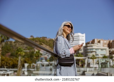 Happy Mature Woman Smiling While Standing Outdoors