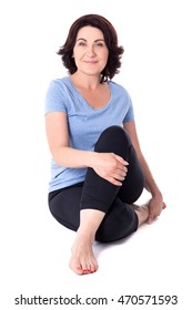 Happy Mature Woman In Sportswear Sitting In Yoga Pose Isolated On White Background