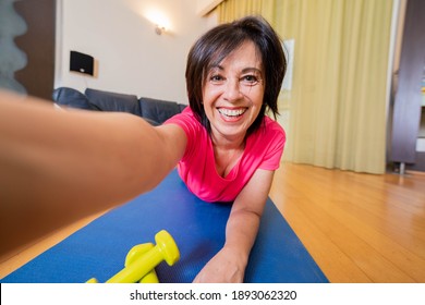 Happy Mature Woman Taking A Selfie Doing Fitness Workout At Home -Concept About People And Domestic Gym - Bright Filter