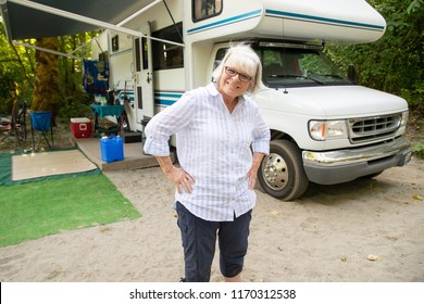 Happy Mature Woman With White Hair Camping With RV