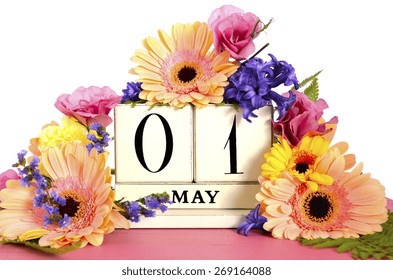 Happy May Day Vintage Wood Calendar Decorated With Spring Flowers On Pink Wood Table. 