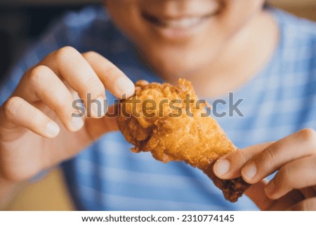 Happy meal, woman smile enjoy eating fried chicken delicious fatty fast food.