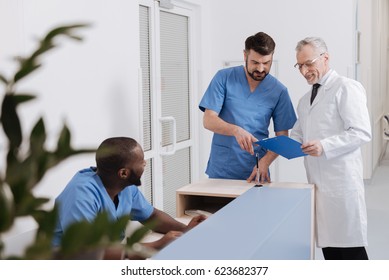 Happy Medical Coworkers Sharing Opinions In The Clinic