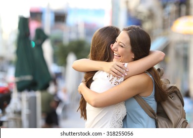 Happy Meeting Of Two Friends Hugging In The Street