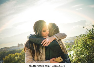 Happy Meeting Of Two Friends Hugging At Sunset Outdoor - Pleasant Moment Of Young Sisters Embracing In The Wilderness As The Sun Shines Upon Them - Vignette Editing