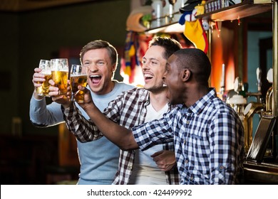Happy men with beer in pub