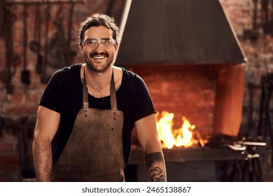 Happy, metal worker and portrait in workshop with apron for manufacturing, welding and blacksmith. Tradesman, smiling and confident in factory with fire for artisan, craftsman and manual labor - Powered by Shutterstock