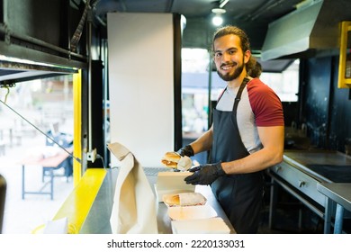 Happy mexican cook finishing preparing sandwiches at the food truck - Powered by Shutterstock