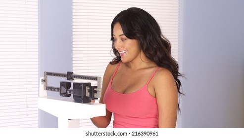 Happy Mexican Woman On Weight Scale