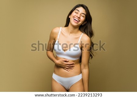 Happy mexican woman in white underwear laughing and having fun with body acceptance and self love 