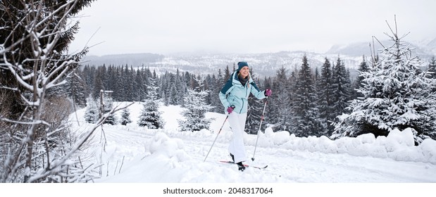 Happy Mid Adult Woman  Skiing Outdoors In Winter Nature, Tatra Mountains Slovakia.