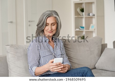 Similar – Image, Stock Photo woman using mobile phone outdoors in nature. beautiful black labrador besides.