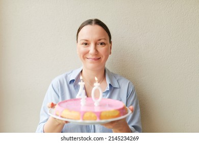 Happy Middle Age 40 Year Old Woman Holding Cake With Candles