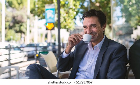 Happy middle age businessman portrait drinking a coffee outdoors in Rome, Italy.  - Powered by Shutterstock