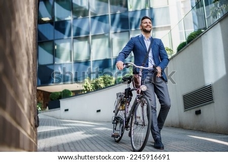 Happy middle age caucasian stylish businessman going to work by bike.