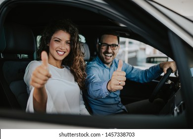 Happy Middle Age Couple Enjoying While Choosing And Buying New Car At Showroom.