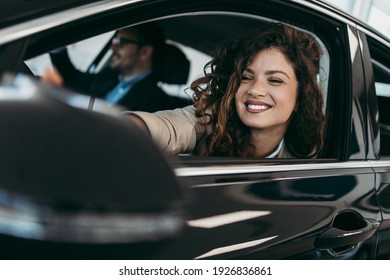 Happy Middle Age Couple Enjoying While Choosing And Buying New Car At Showroom.