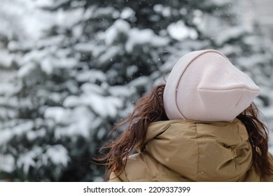 Happy Middle Age Woman Catching Snowflakes In The City Outdoors. Relaxed Emotional Person Walking In Winter Urban Area In A Moment, Slow Living, Sincere Authentic Life