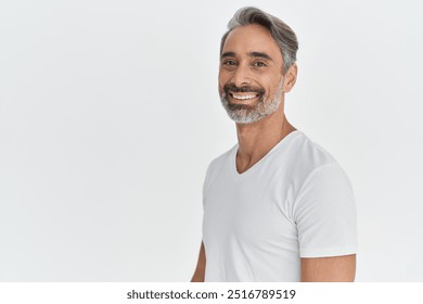 Happy middle aged 45 years old man isolated on white studio background. Confident mature handsome bearded gray-haired male model wearing t-shirt looking at camera. Portrait. Copy space. - Powered by Shutterstock