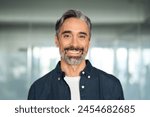 Happy middle aged 50 years old professional business man, smiling older executive manager, mature bearded businessman entrepreneur standing in office at work looking at camera, headshot portrait.