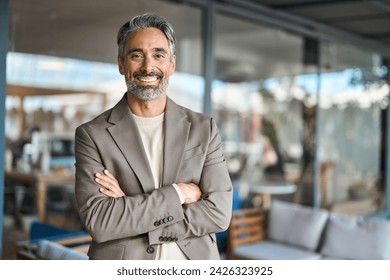 Happy middle aged business man entrepreneur looking at camera outdoors. Smiling confident mature businessman professional executive, successful lawyer wearing suit standing arms crossed, portrait. - Powered by Shutterstock